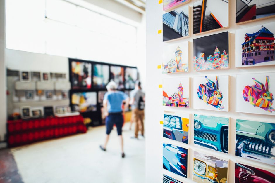 Framed paintings on the wall of a modern art gallery